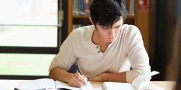 Male student working on an essay